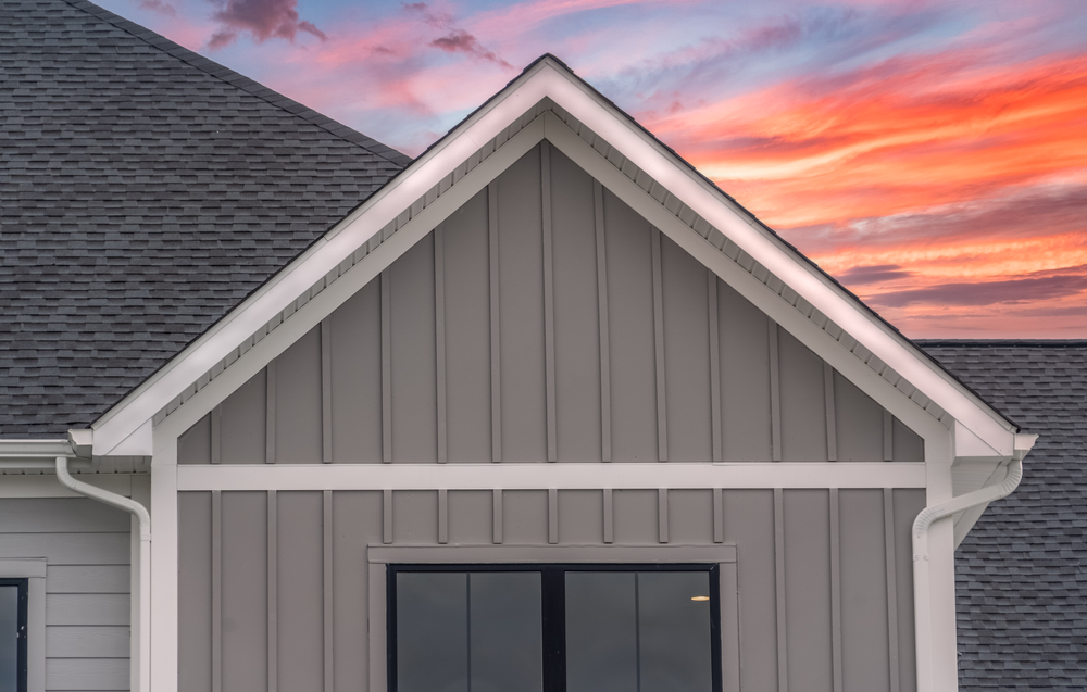 a house with gray siding at sunset