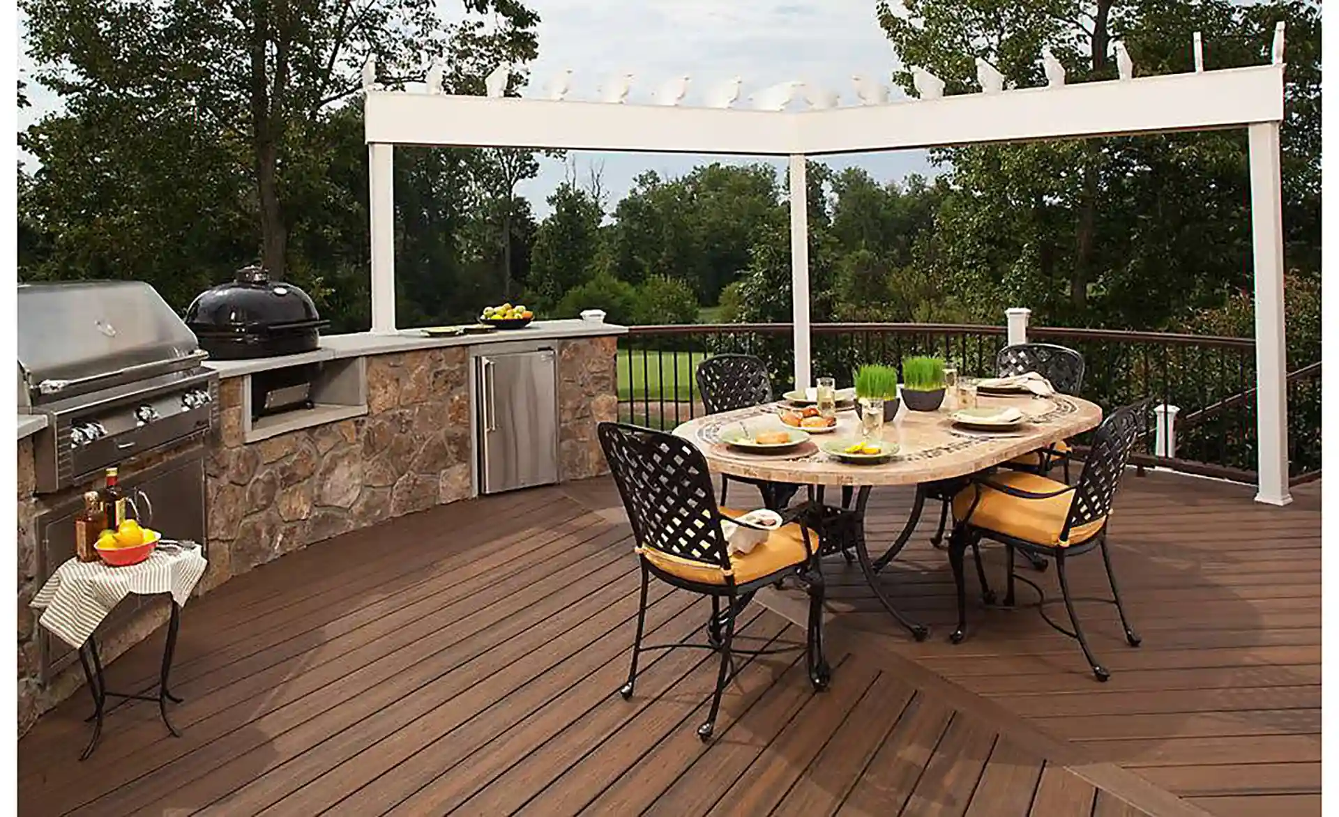 photo of a composite deck with outdoor kitchen and dining area