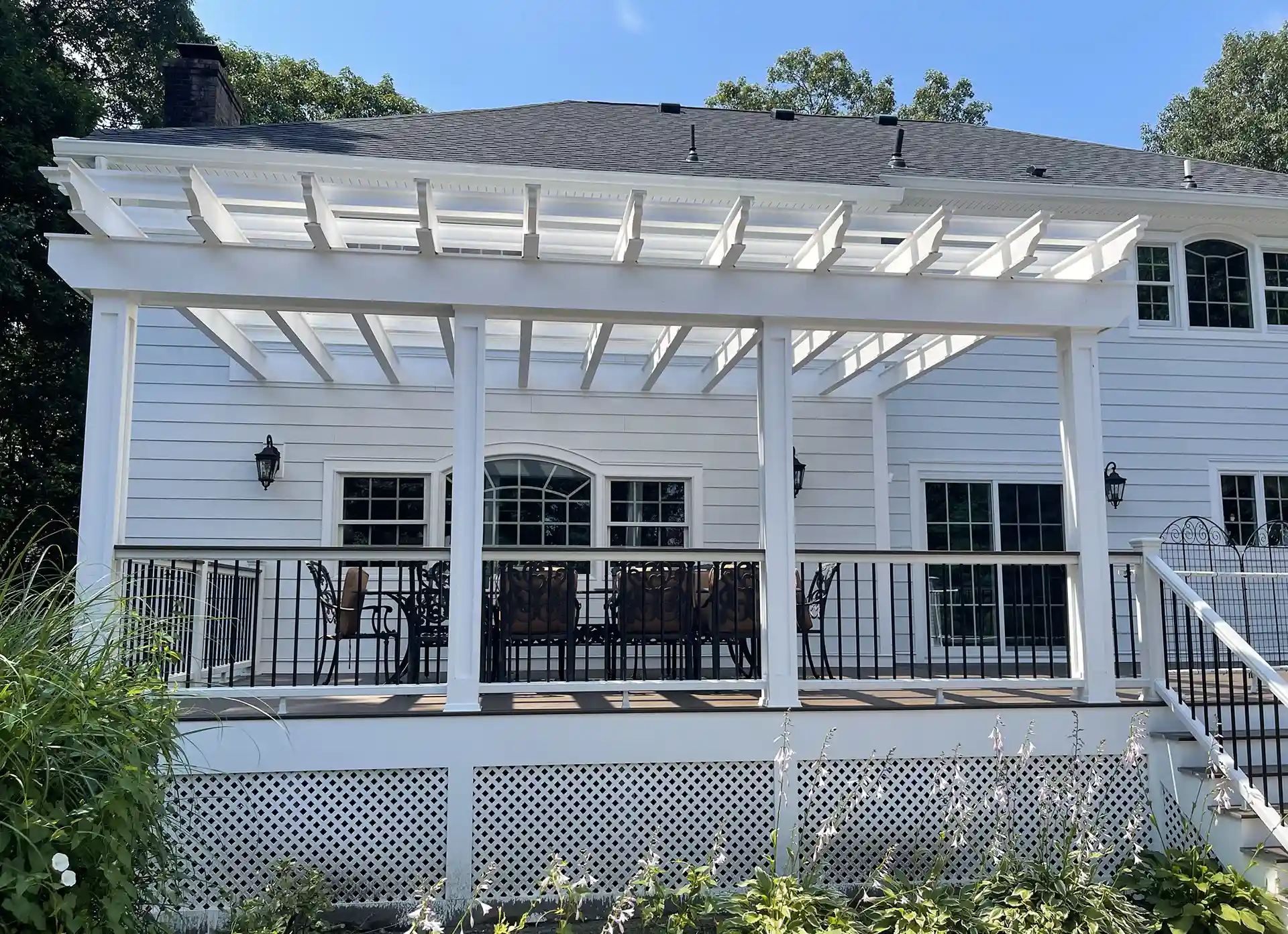 Raised deck with white pergola and lattice deck skirting