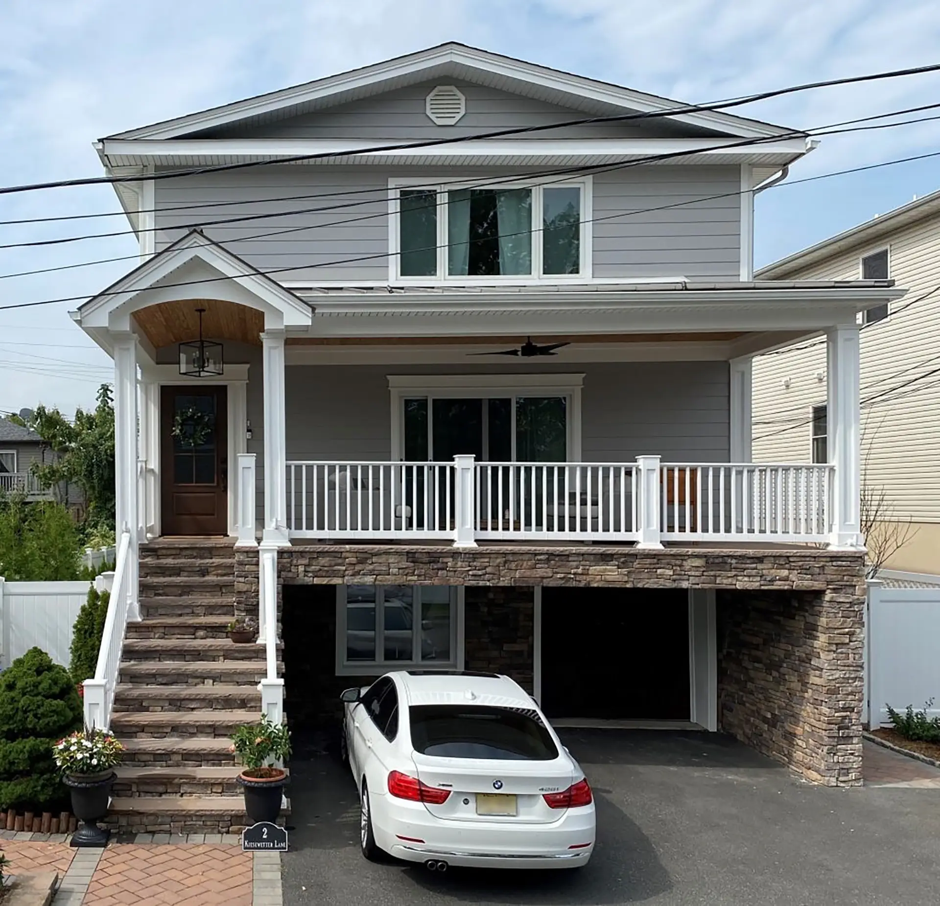 ALT Text photo of a home exterior with steps leading up to covered porch