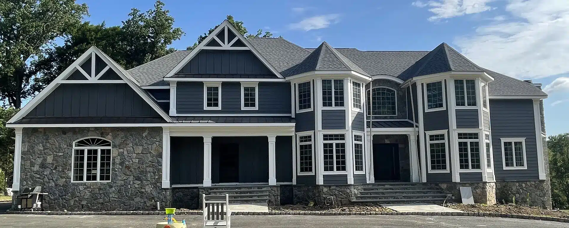 photo of home exterior with new windows, siding, roof, and portico