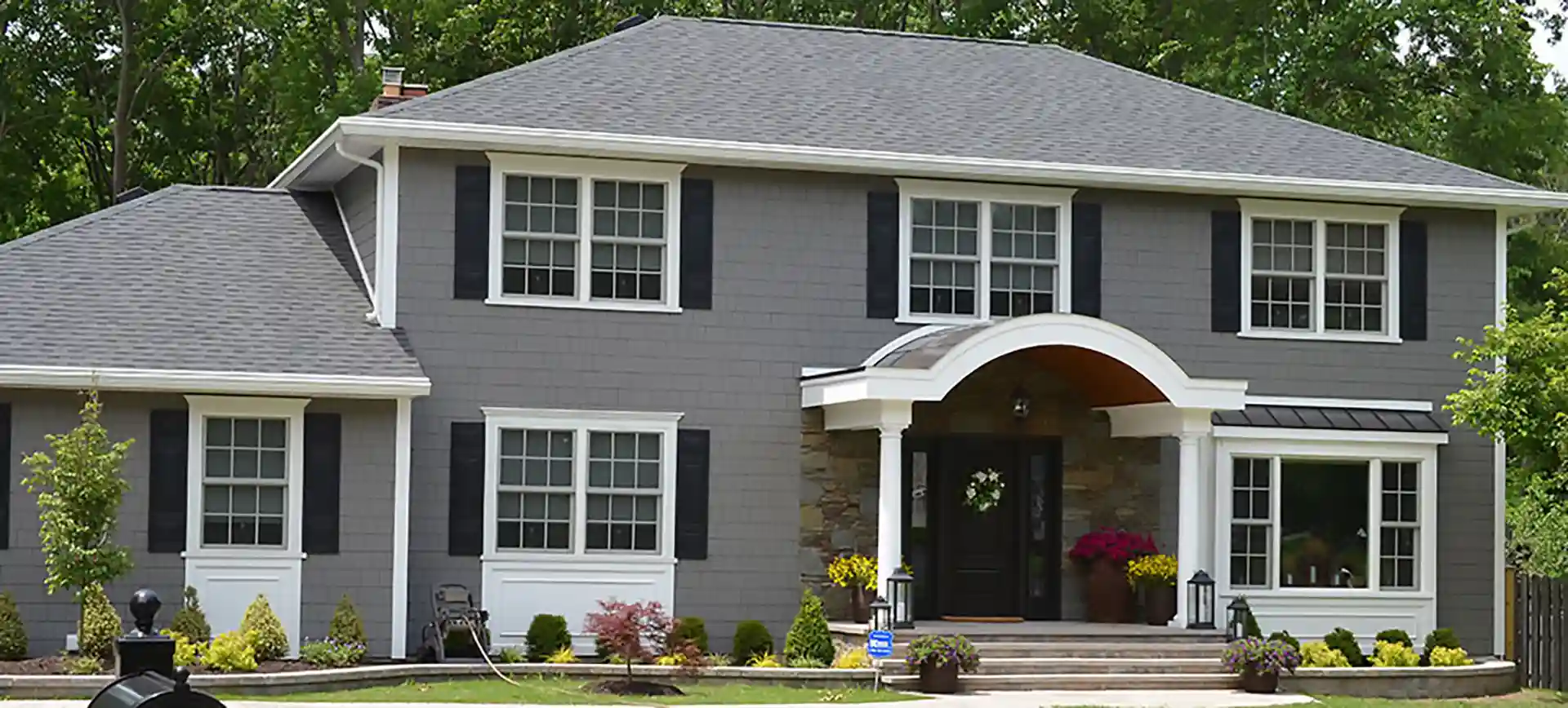 photo of a home exterior with a two-column portico with curved roof